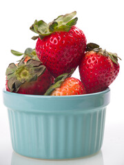 Close up of strawberries in blue bowl.