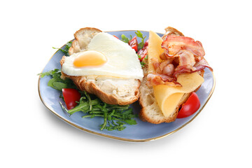 Plate with tasty fried egg, cut croissant, bacon, tomatoes and arugula on white background