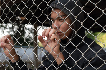 Detention of preteens inside the metal fence and wall because of their bad behavior and habits,...