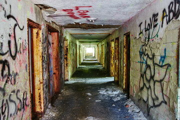 Abandoned Hospital Corridor with Graffiti and Decay, Exploration Perspective - obrazy, fototapety, plakaty