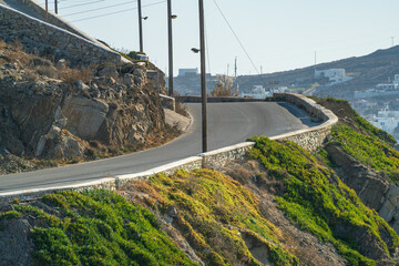 Curvy asphalt road on Mykonos island. Greece