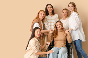 Group of people with woman in wheelchair on beige background