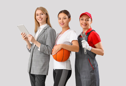 Women of different professions on grey background