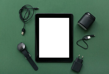Composition with modern gadgets on green background