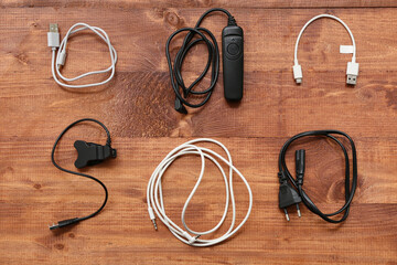 Set of different USB cables on wooden background