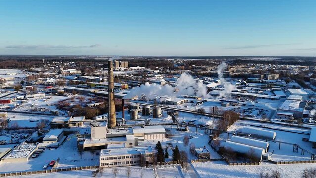 Smoky chimneys seen from above, snow covered buildings, Silute, Lithuania