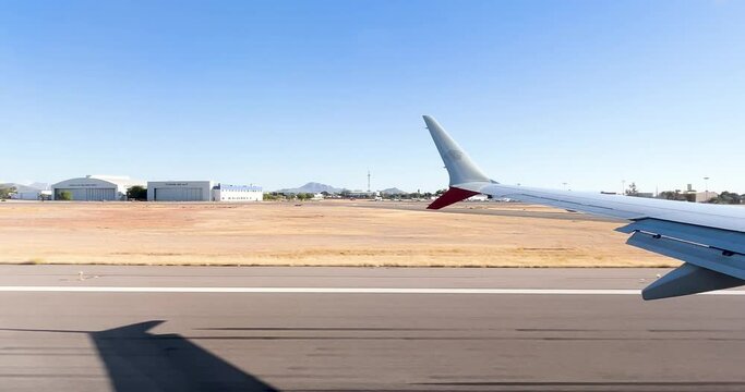window seat view of airplane taking off at runway at hermosillo airport