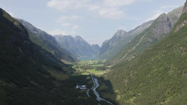 Cinematic Aerial View of Olden Valley in Norway. A river of Glacier Runoff leading into the Oldevatnet surrounded by mountains.