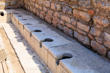 Antique Roman public toilet in the city of Ephesus. Background with selective focus and copy space