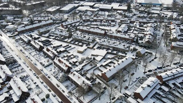 Aerial of beautiful small town covered in snow. The roads are clean and free of ice and snow