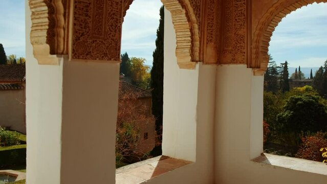 The Alhambra Nasrid Palace beautifully framed by the arabesque-decorated Court of the Main Canal of Generalife in Granada, Anadalucia, Spain