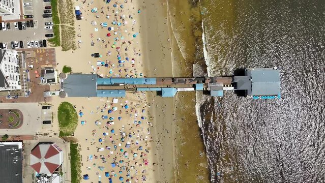 Overhead drone shot of the Old Orchard Pier on Maine's coast.