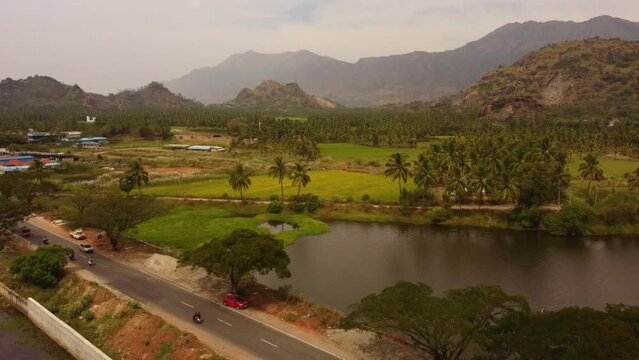 Drone footage of cars driving on Trivandrum-Nagercoil Hwy in Chunkankadai, Tamil Nadu, India