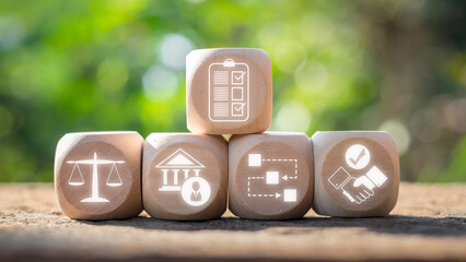 Rules concept. Wooden block on desk with rules icon on virtual screen. Implementation, Authority,...