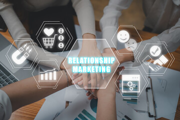 Relationship marketing concept, Business team putting their hands on top of each other with...
