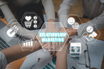 Relationship marketing concept, Business team putting their hands on top of each other with relationship marketing icon on virtual screen. Public Relations, Strategy, SEO, Social Media.