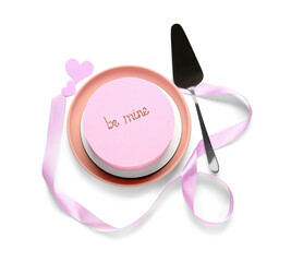Pink bento cake with spatula and ribbon on white background. Valentine's Day celebration
