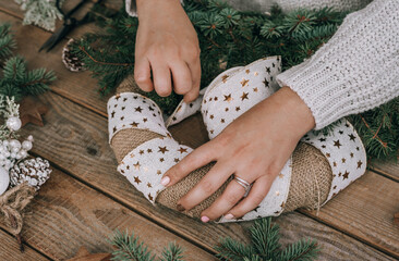 Close-up photo of female hands making christmas wreath