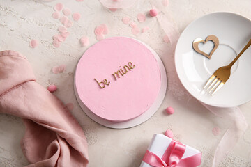 Pink bento cake with gift box and napkin on beige grunge background. Valentine's Day celebration