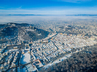 Aerial view of the old historic town of Brasov during a sunny day in winter, Romania