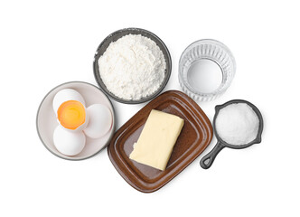 Eggs, butter, flour, salt and water isolated on white, top view. Ingredients for puff pastry dough