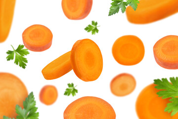 Fresh carrot slices and green parsley falling on white background