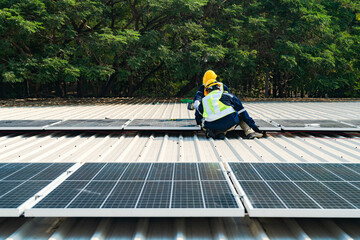 Worker Technicians are working to construct solar panels system on roof. Installing solar photovoltaic panel system. Men technicians carrying photovoltaic solar modules on roof.