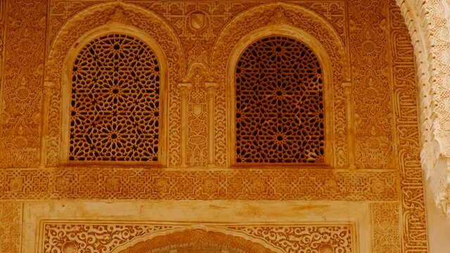 The Alhambra Palace - Gorgeous embossed decorations, arabesques and latticework of the Palace of Comares in Granada, Andalucia, Spain
