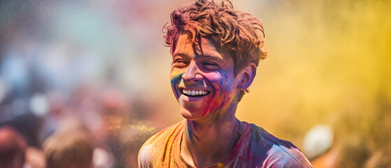 A man happily celebrates the Holi festival with colorful paint on his face.