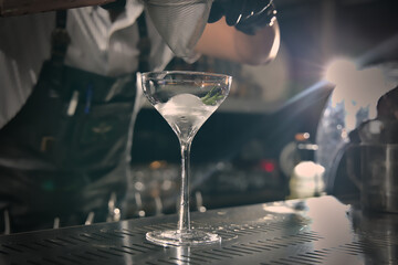 Close-up view of a cocktail glass on the bar counter.