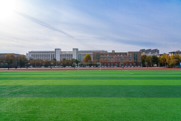 In the school yard:a football field and school building.