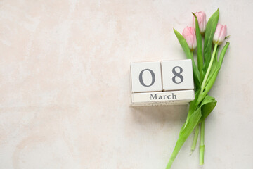 Cube calendar with date 8 MARCH and beautiful tulips on white background. International Women's Day