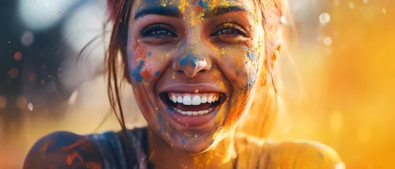 Fotobehang A woman's face reflects joy during Holi festival celebration with colorful paint © Jess rodriguez