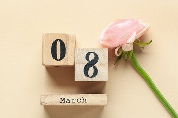 Cube calendar with date 8 MARCH and beautiful flower on yellow background. International Women's Day