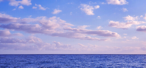 Tropical horizon over the sea with pink clouds