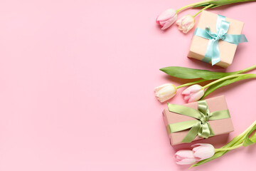 Beautiful tulips and gift boxes on pink background. International Women's Day