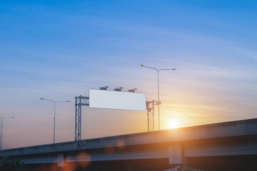 Empty white billboards on city streets at sunset sky for advertising along the roads.