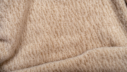 Fototapeta na wymiar Beige coat fabric, alpaca. Texture of warm wool fabric. Winter clothes. Natural wool, beige wool pile fabric.