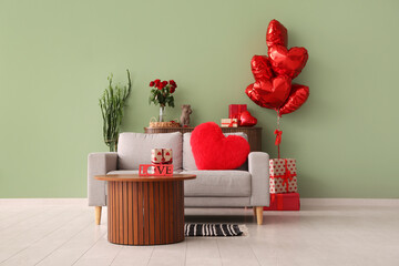 Interior of festive living room with grey sofa, heart-shaped cushion and balloons. Valentine's Day...