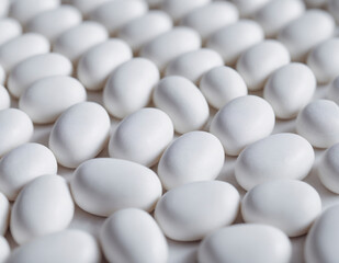 white pills on white background.