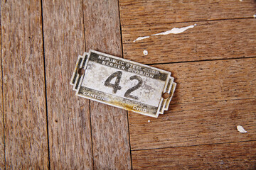 Vintage 42 Steel Corp Tag on Weathered Wood