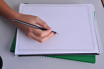 garoto escrevendo em folha branca de caderno 