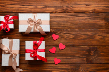 Composition with different gift boxes and hearts for Valentine's Day celebration on wooden...