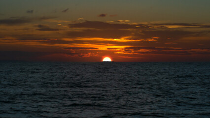 Coastal evening landscape. Beautiful dusk sky over ocean