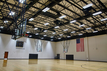 Spacious Indoor Basketball Court with American Flag and Hoops