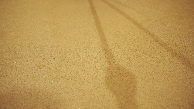 Cleaning water off linoleum floor using squeegee 