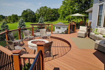Luxury Outdoor Deck with Fire Pit Seating and Rattan Lounge Area