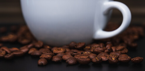 Close up white ceramic cup of coffee with beans, banner size