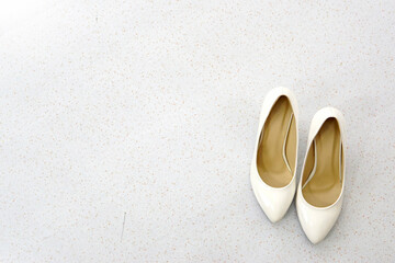 a pair of white high heels shoes ( stilettos )