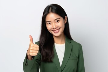 confident asian woman showing thumb up, isolated on white background 